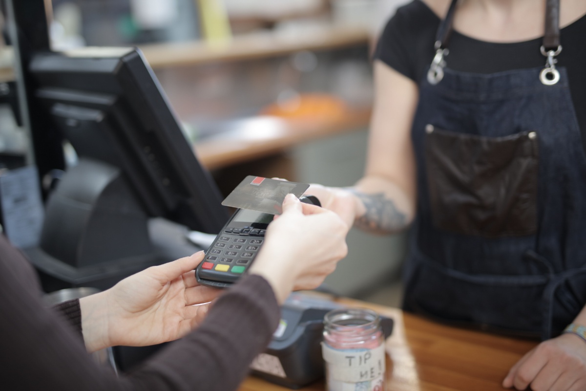 Customer paying a bill at a retail counter