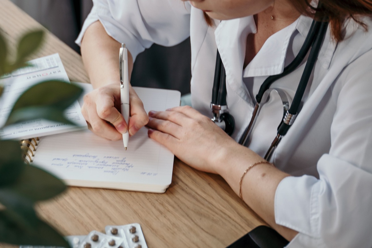 Doctor writing a prescription before pharmacy dispensing