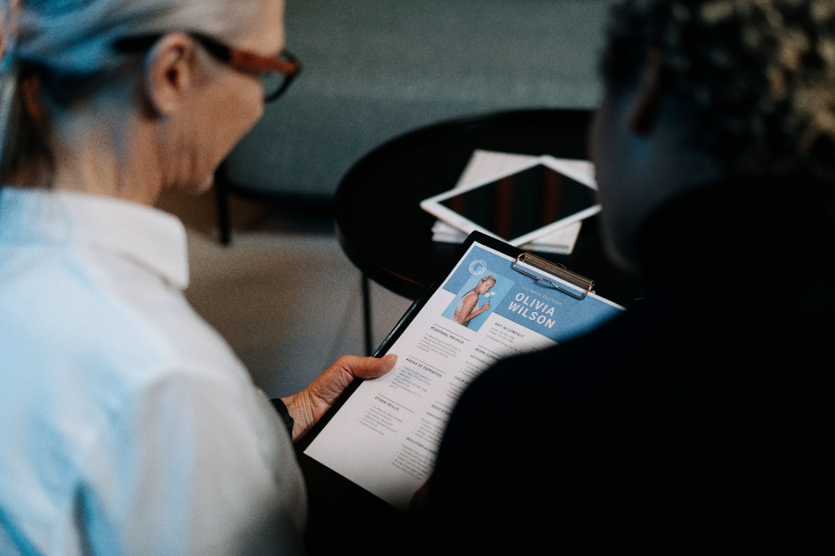 Recruiters reviewing a candidate resume during hiring