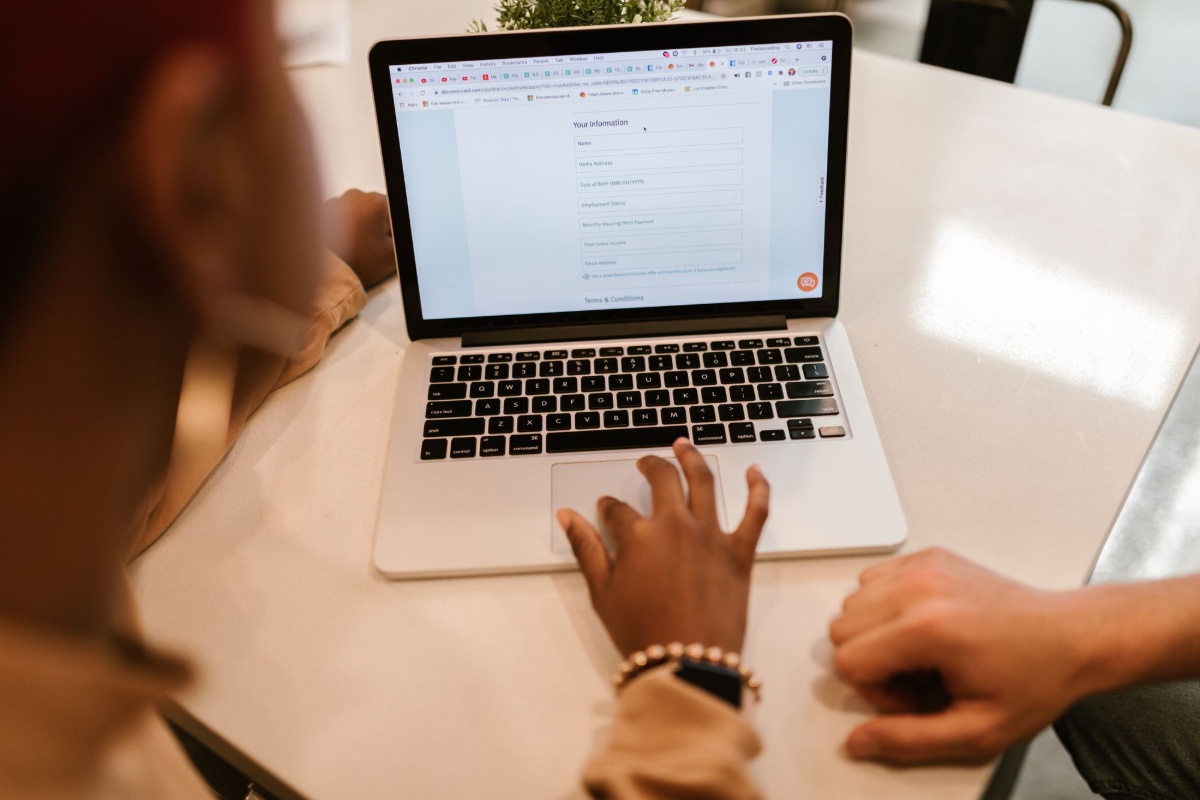 Resident completing an online application form on a laptop