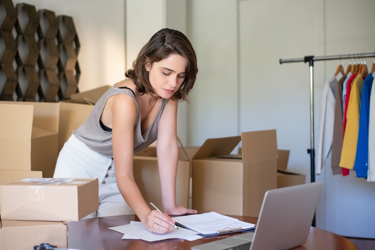 Resident organizing paperwork among moving boxes