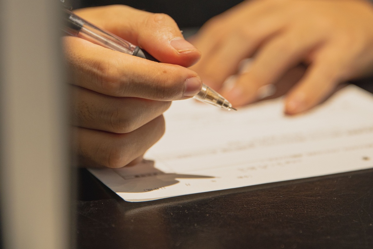 Person filling out address-change paperwork
