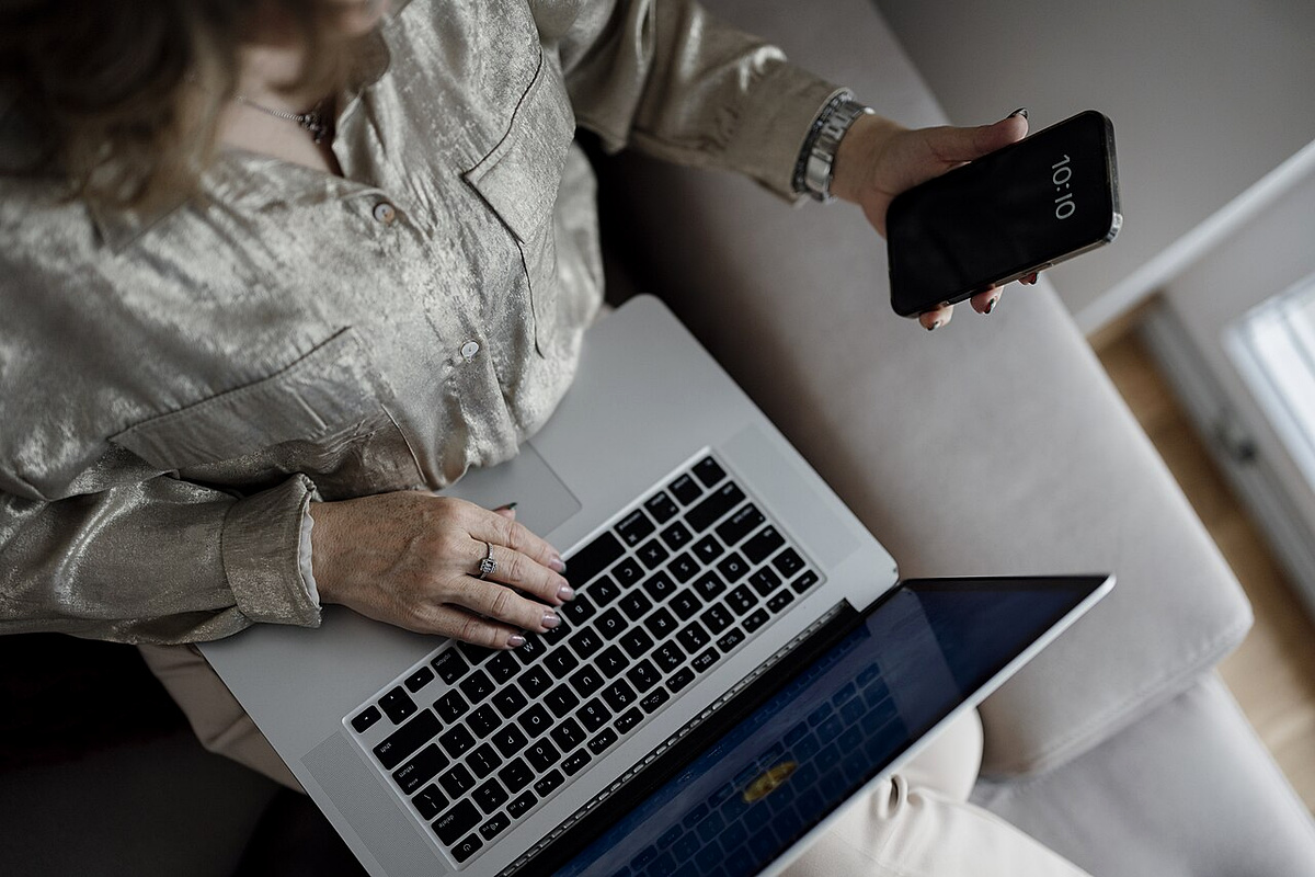 Resident managing an internet cancellation account on a laptop and smartphone