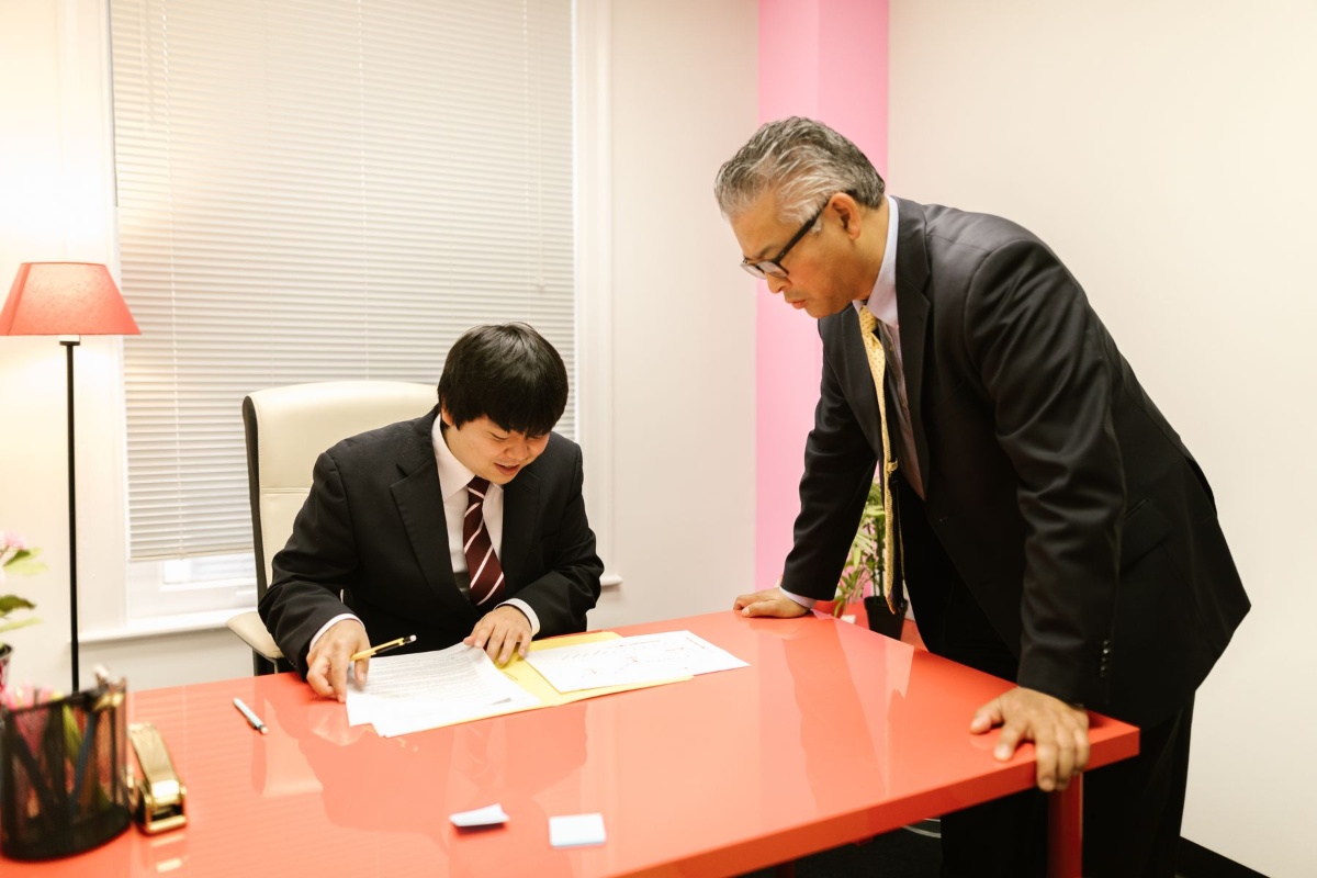 Employee discussing insurance enrollment paperwork with a workplace representative