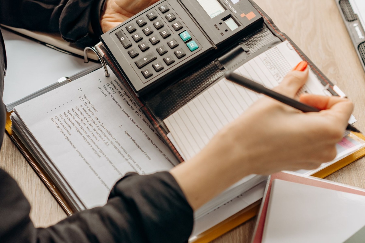 Calculator and paperwork used to compare health insurance costs