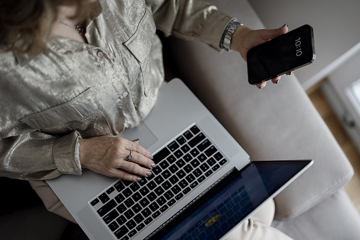 Resident checking an online municipal certificate application on a laptop and phone