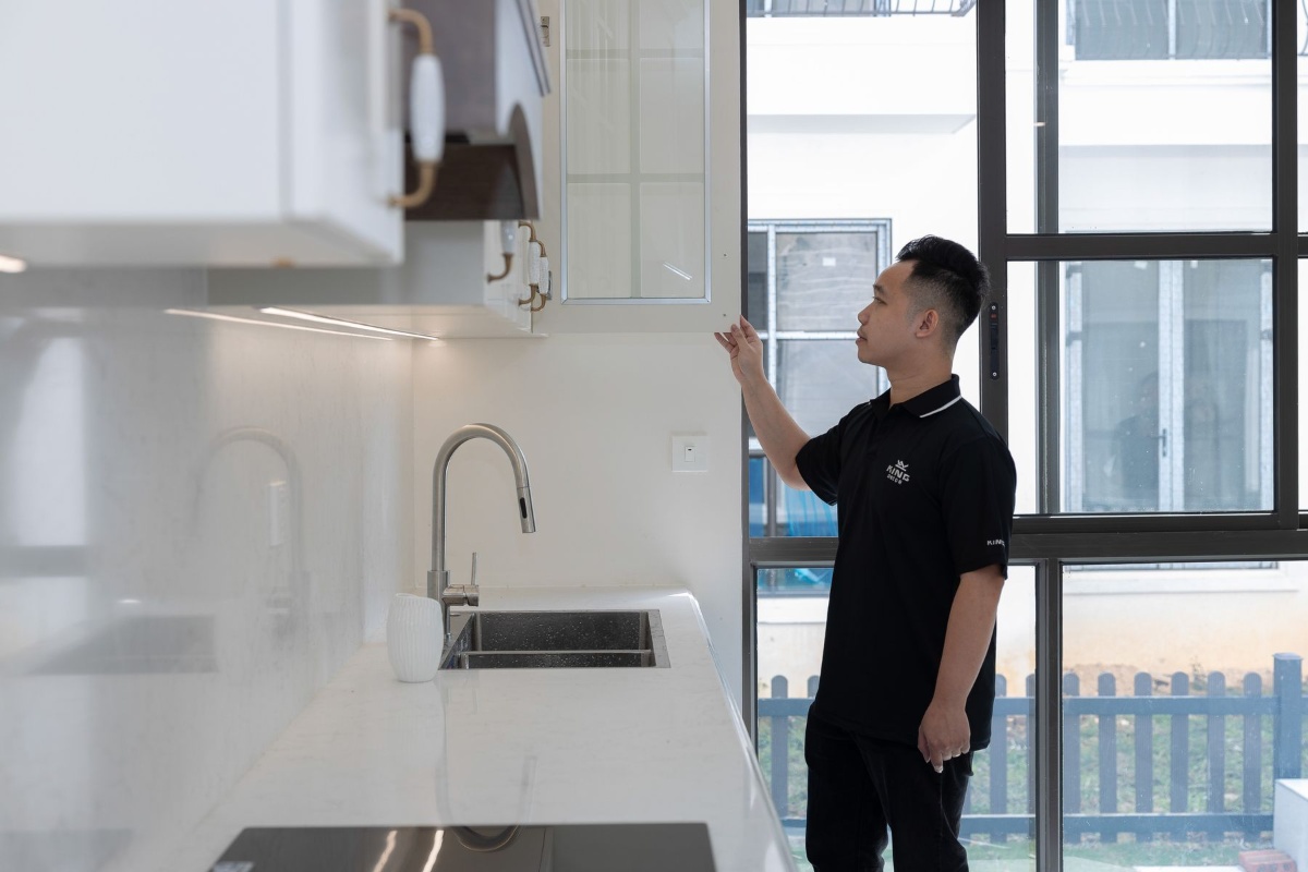 Inspecting kitchen fixtures and cabinets before moving into an apartment