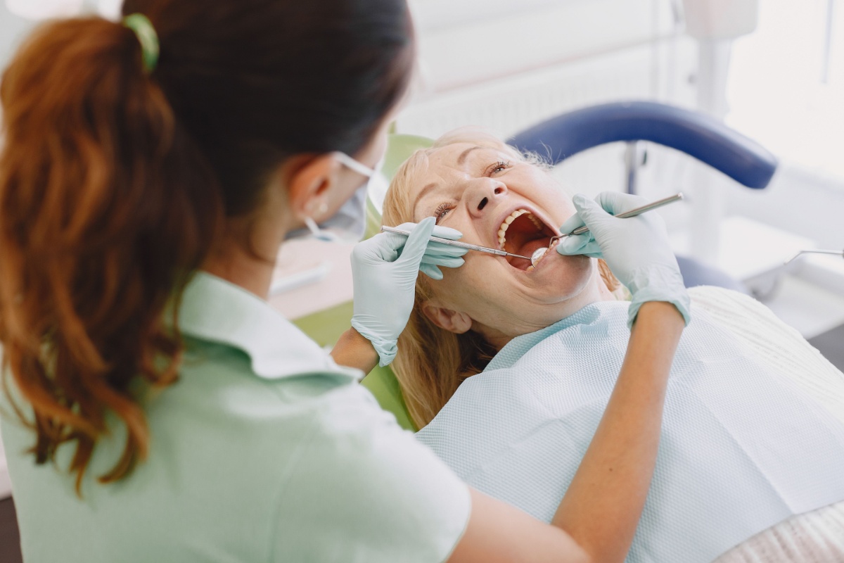 Dentist examining a patient's teeth during a dental visit