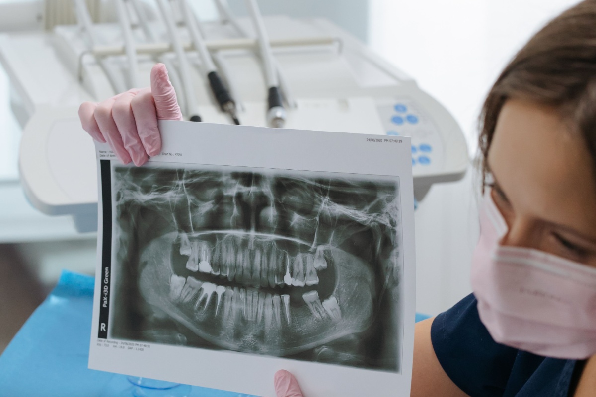 Dentist explaining a panoramic dental X-ray to a patient