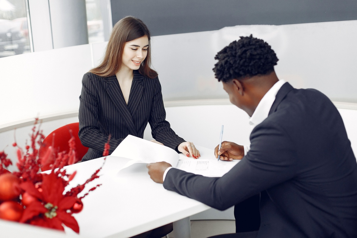 Professional signing a new employment agreement during a job change