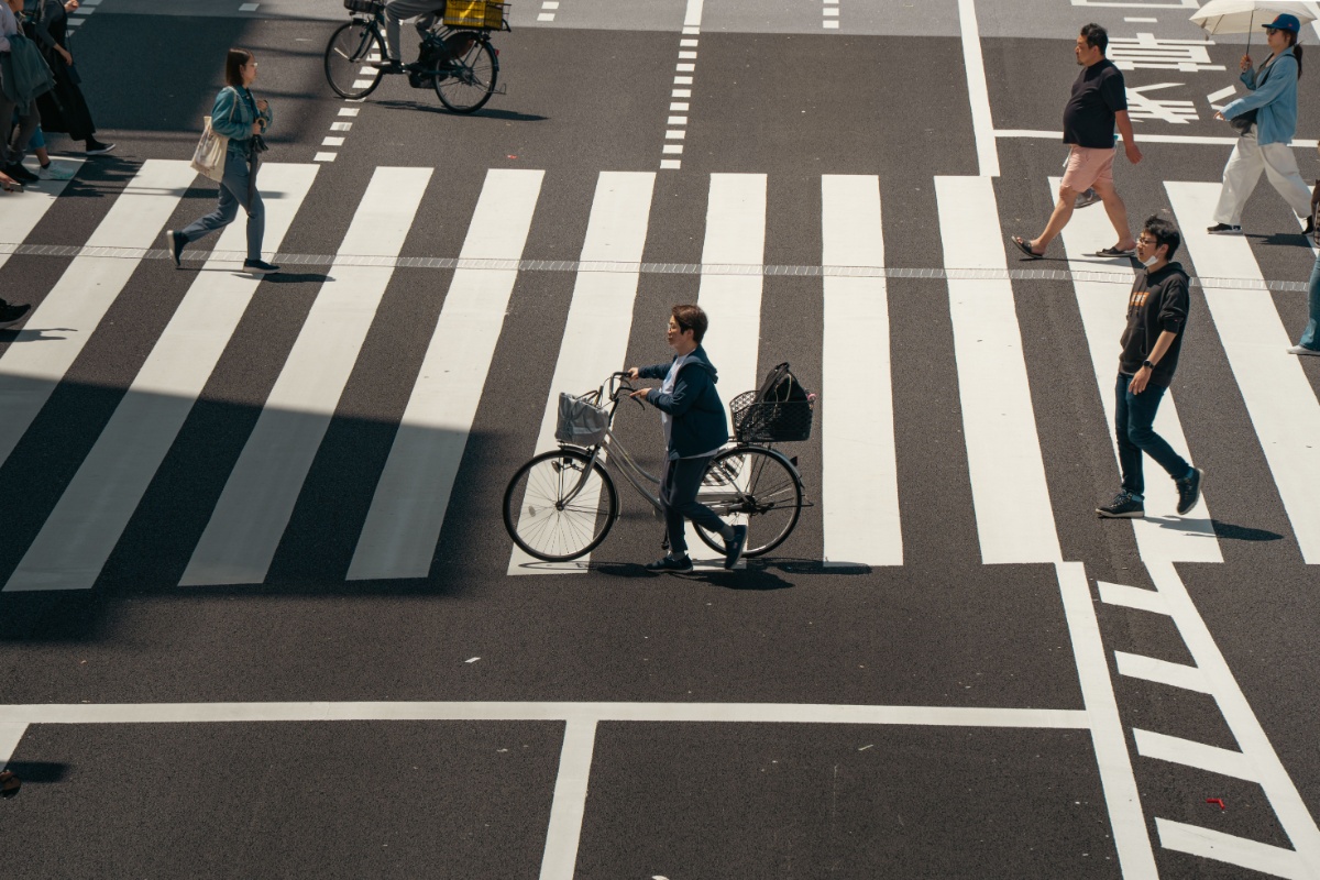 Cyclist crossing a zebra crossing in Tokyo viewed from above