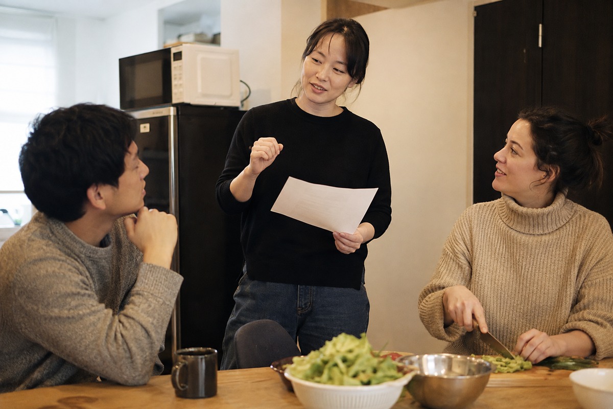Housemates talking in a shared kitchen after moving into a share house