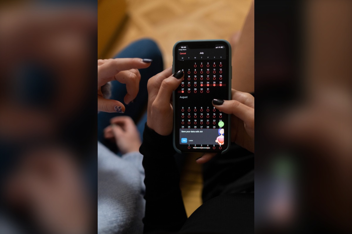 Hands using a smartphone calendar