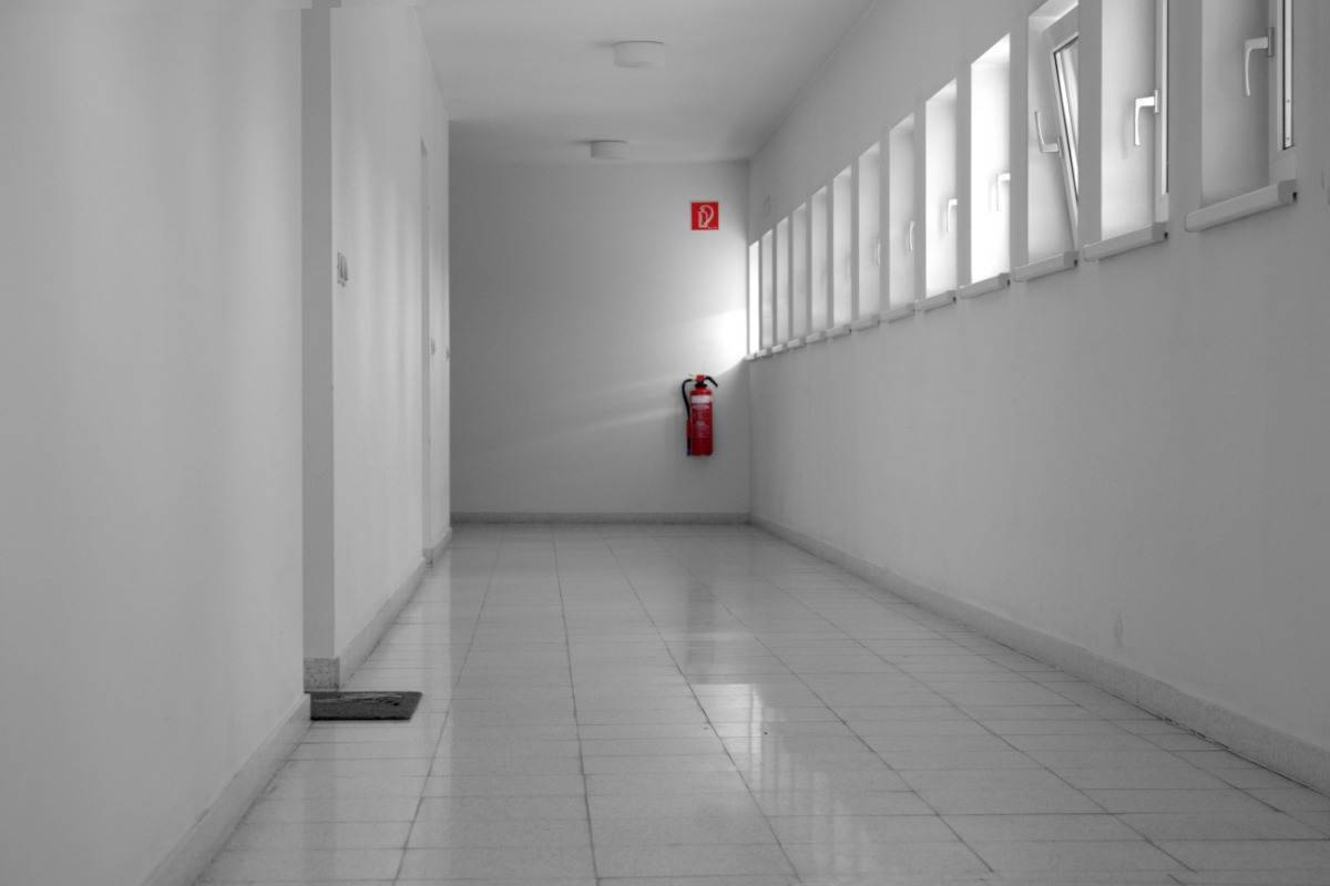 Fire extinguisher in a clean residential-style corridor