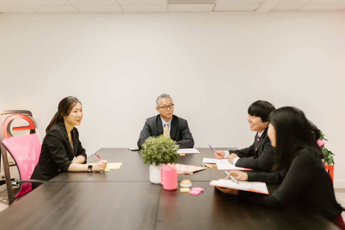Japanese professionals in an office team meeting
