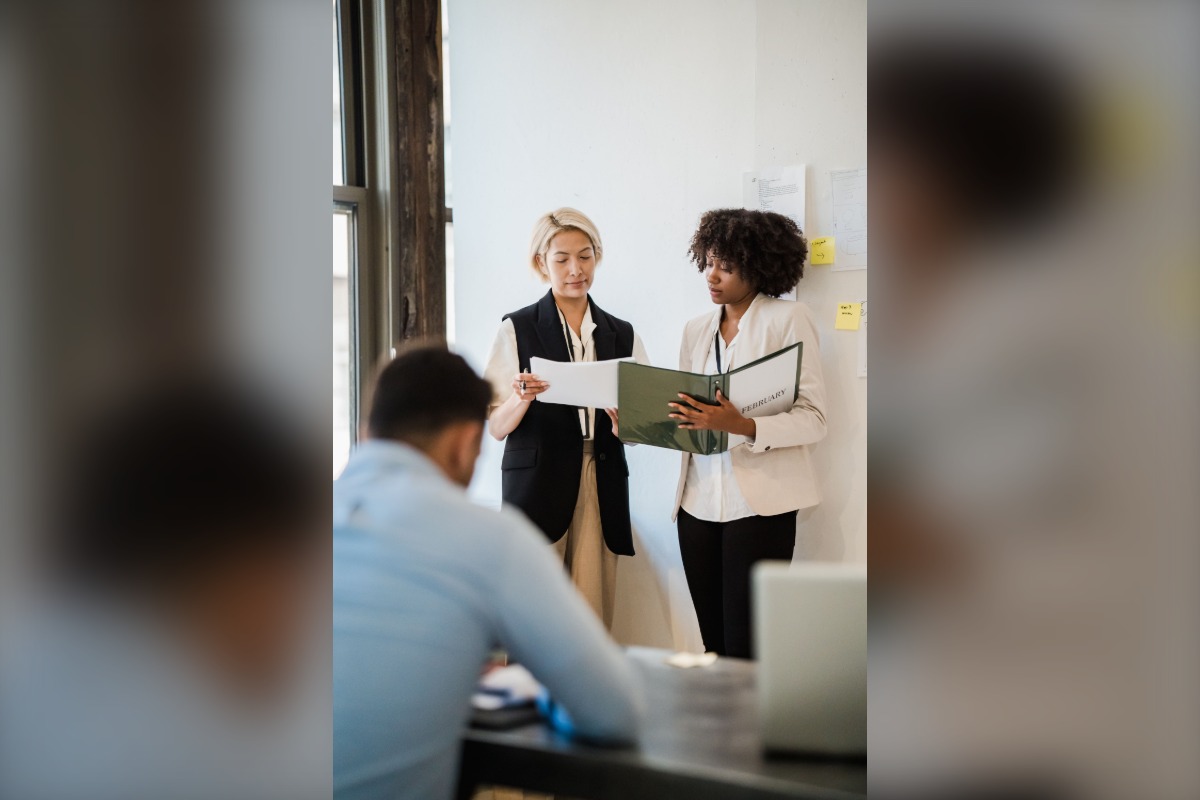 Office professionals reviewing workplace documents