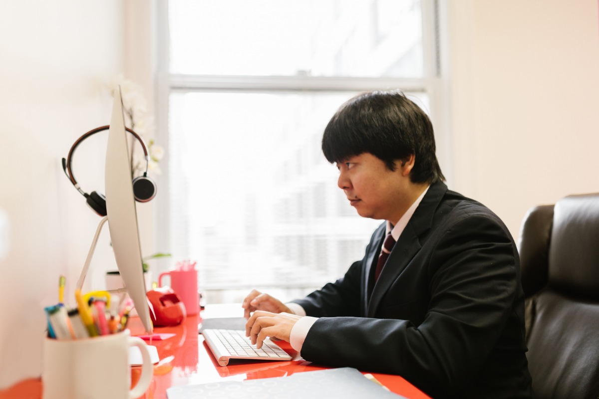 Japanese office worker at a desktop computer