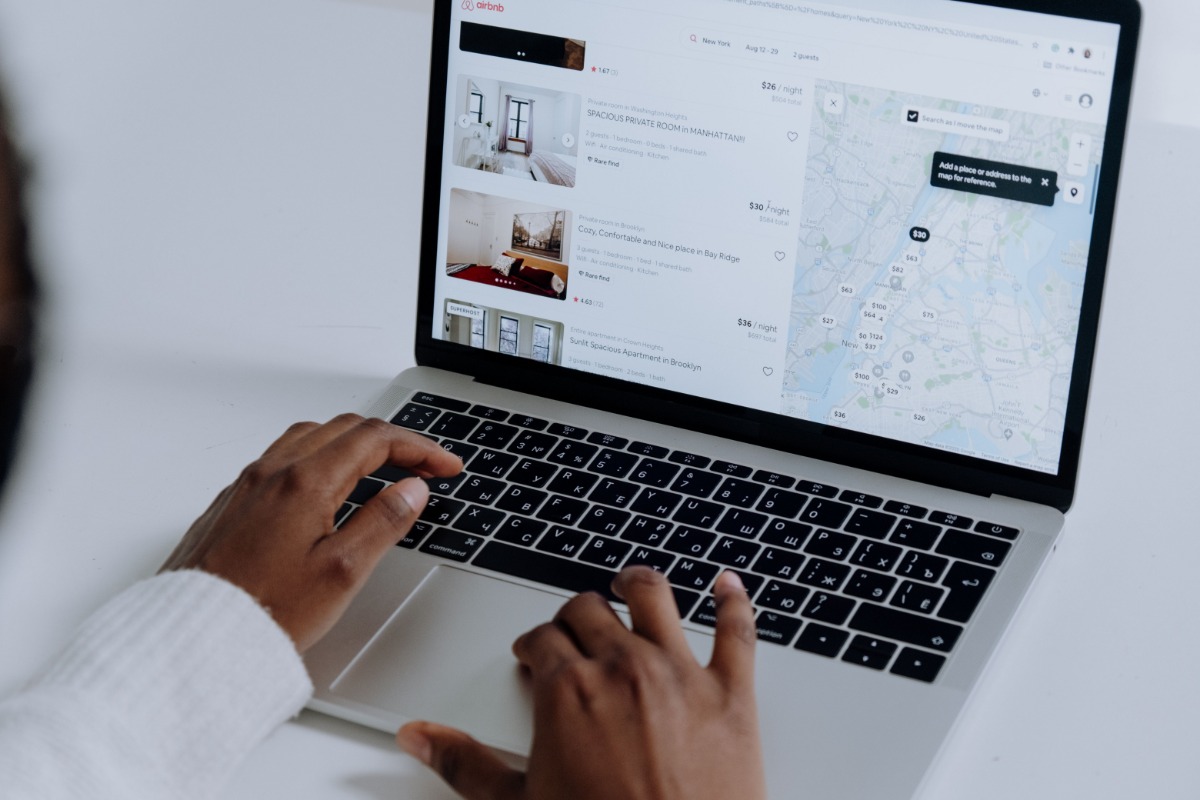 Person searching property listings on a laptop