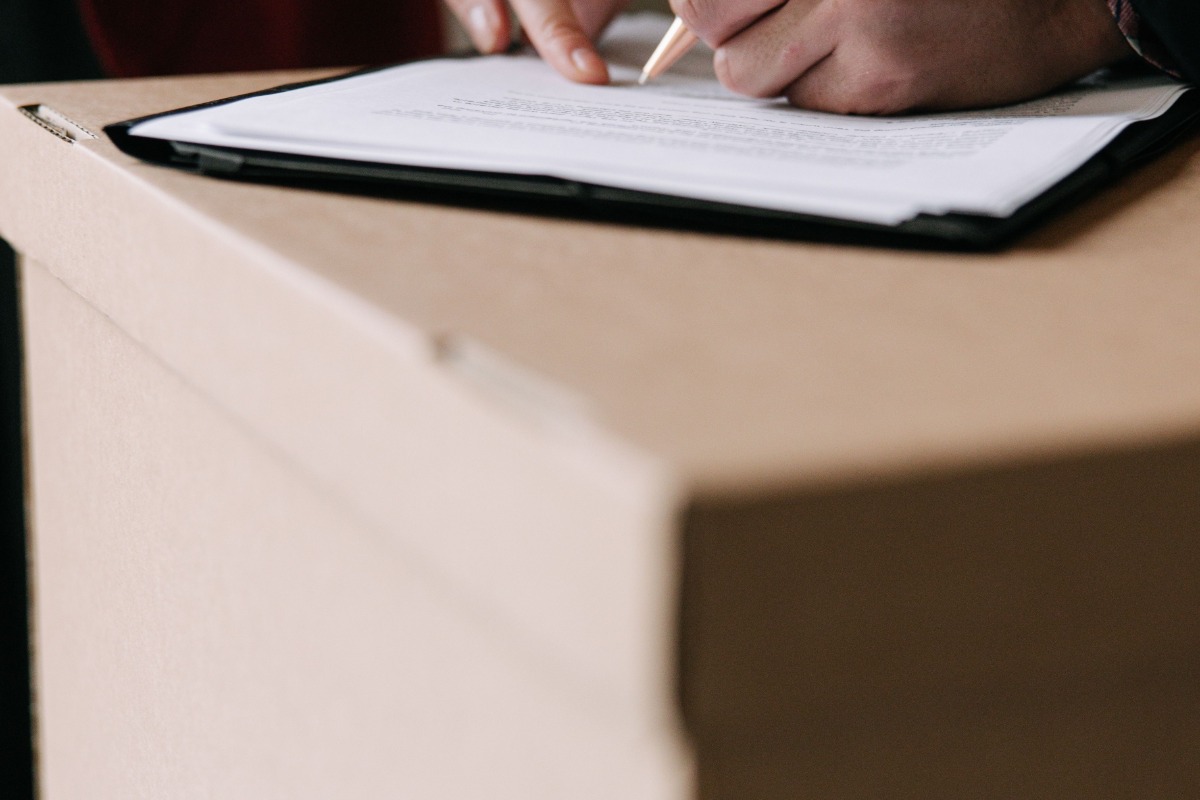 Hands signing rental agreement paperwork