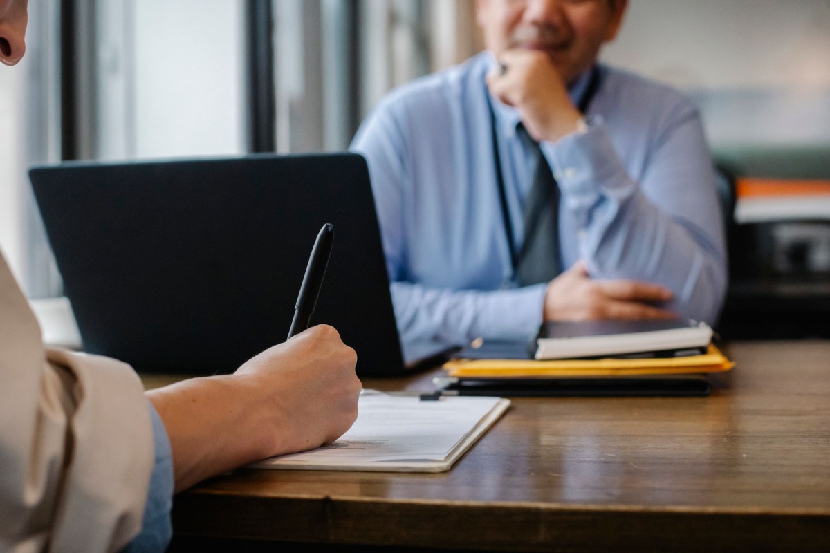 Candidate reviewing job application documents with a recruiter