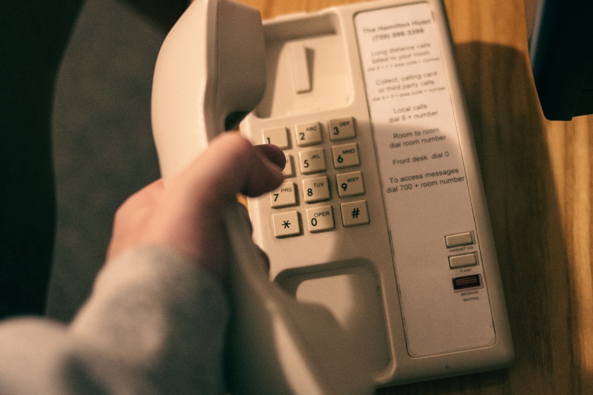 Person using a landline telephone for a business or service call