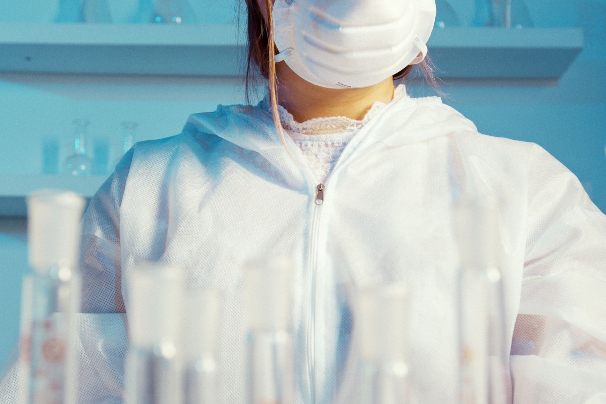 Patient preparing for an online doctor visit with a thermometer and notes
