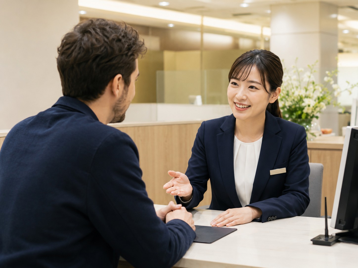 Foreign resident discussing an overseas remittance with bank staff in Japan