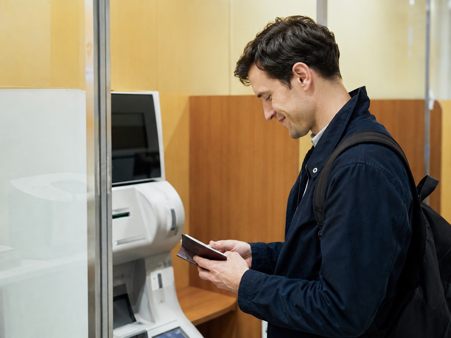 Foreign resident checking an overseas payment at a bank ATM area in Japan