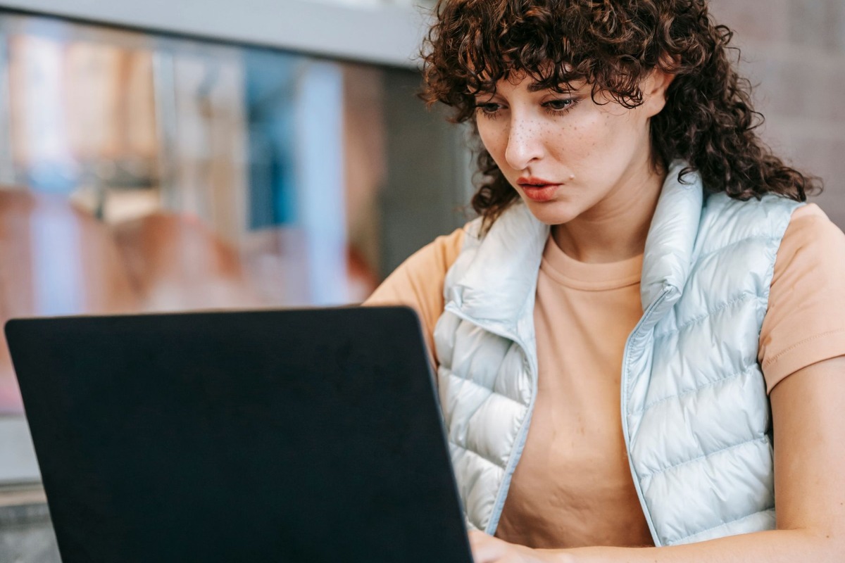 Freelancer working on a laptop in a city cafe