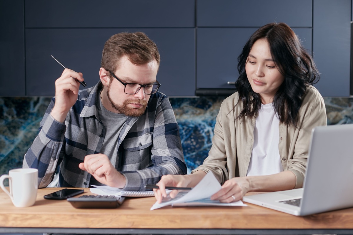 Couple reviewing household utility bills at home