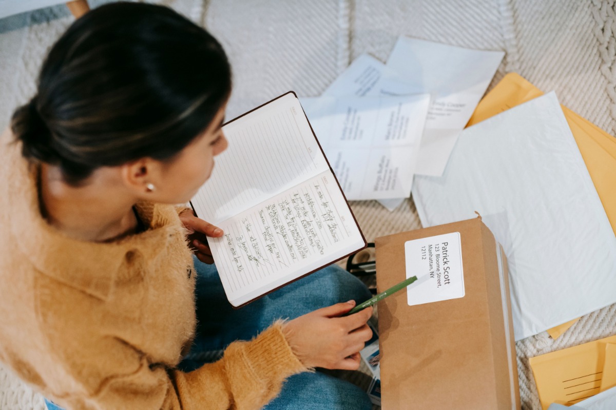 Person checking address details on a parcel label