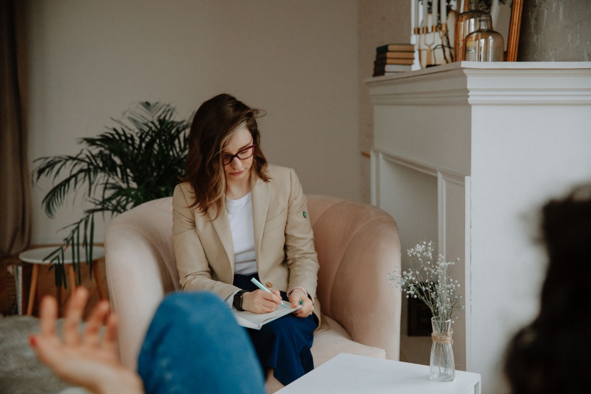 Therapist taking notes during a counseling session