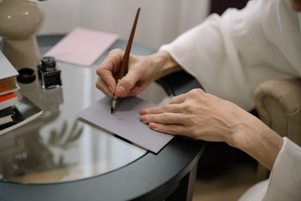 Person preparing an envelope for a postal application