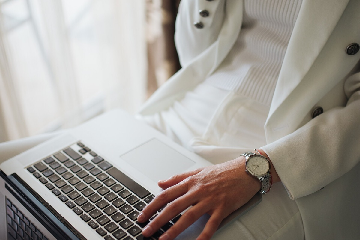 Professional searching for jobs on a laptop