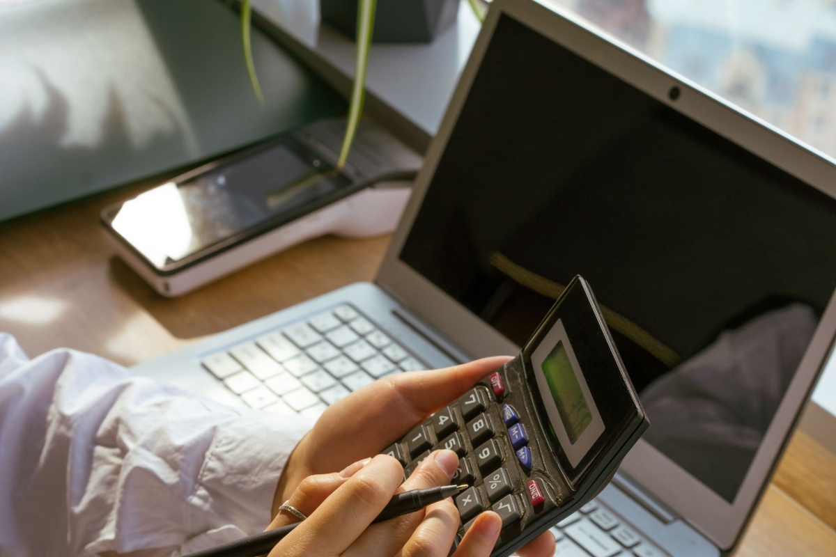 Person managing online banking and payments at a laptop