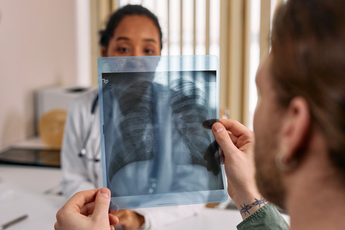 Patient and doctor reviewing a chest X-ray after a health examination