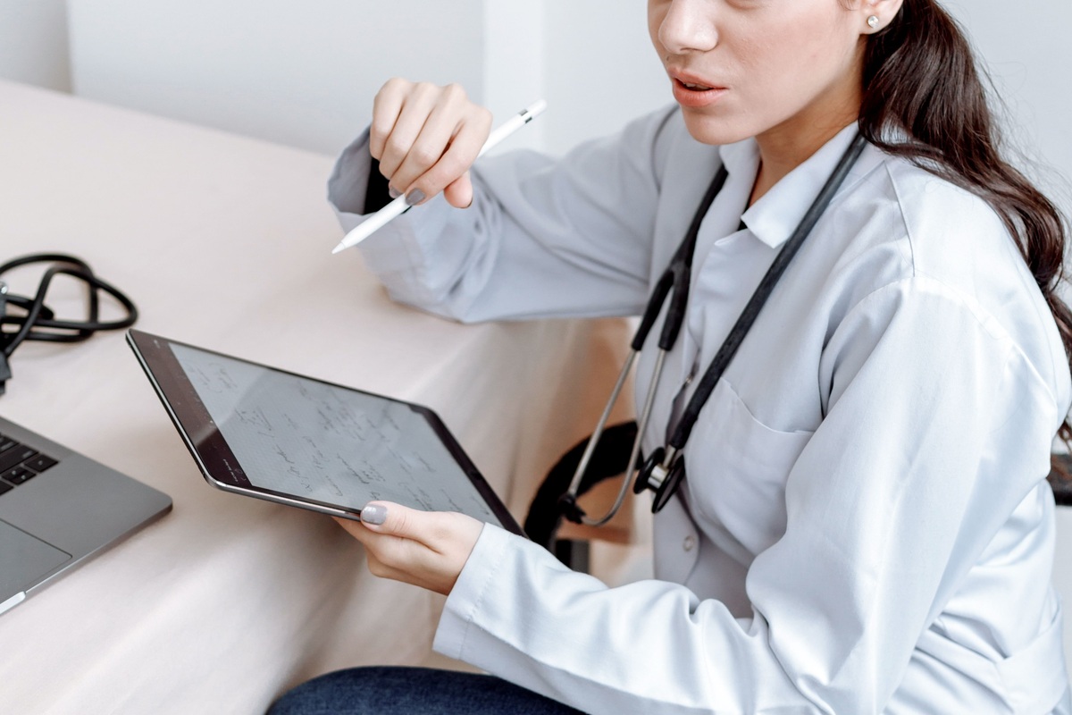 Clinician discussing health checkup results with a patient using a tablet