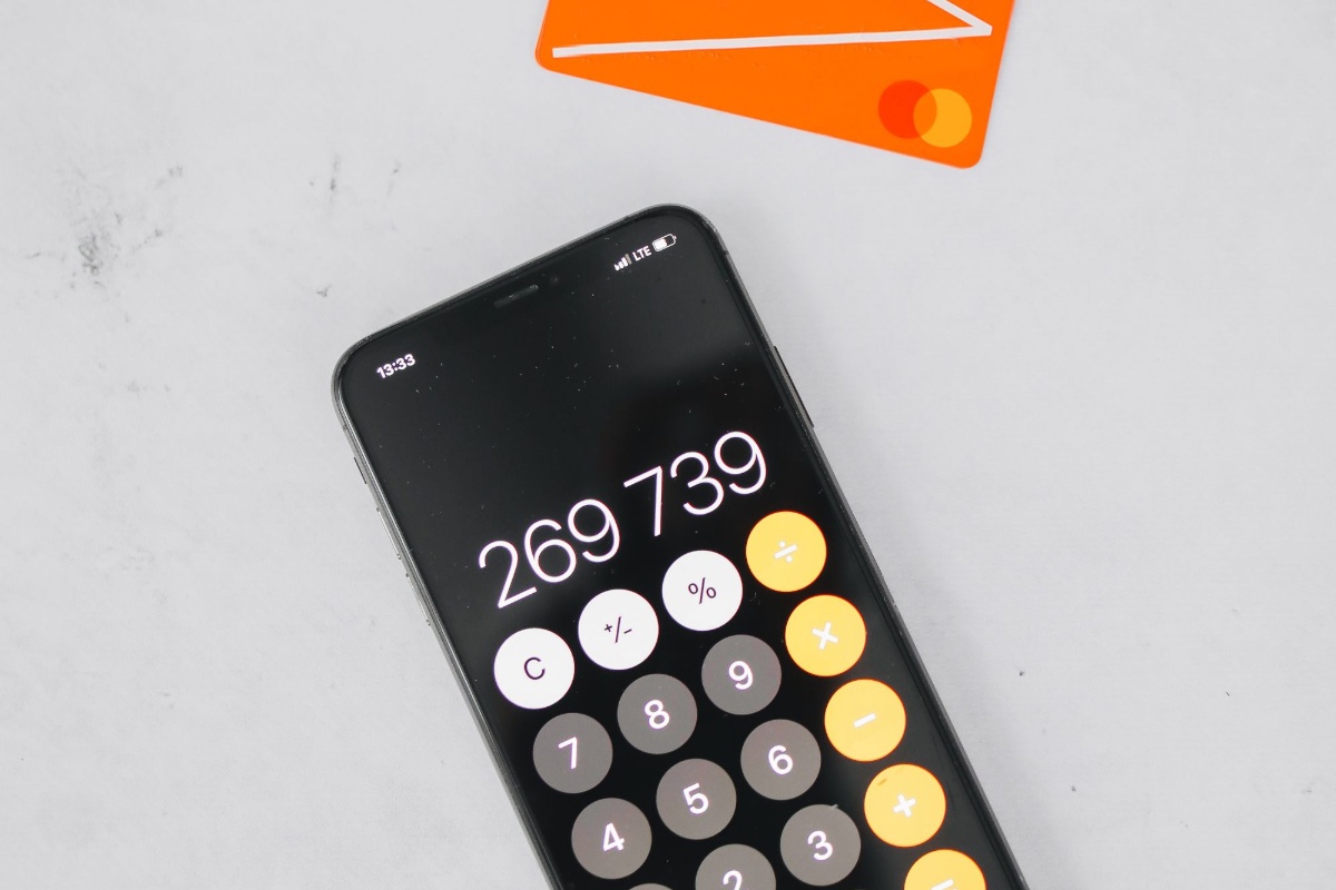Smartphone calculator and bank card used to compare banking fees