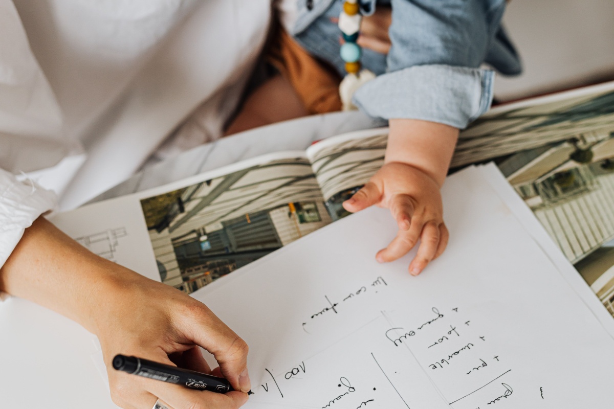 Parent with baby preparing child allowance application paperwork