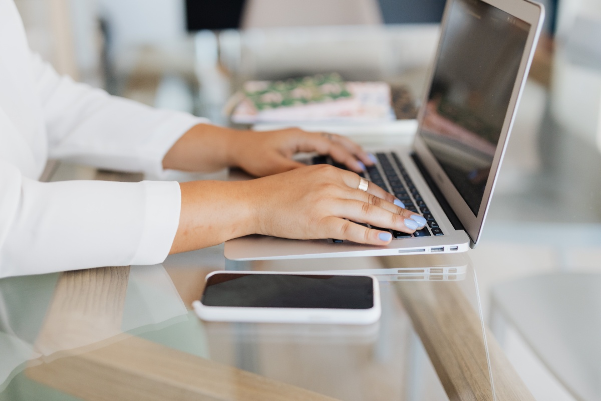 Person typing a practical Japanese email on a laptop