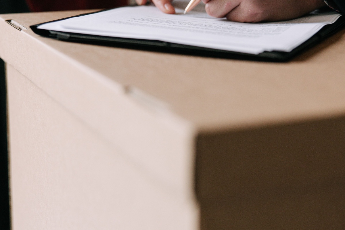 Tenant reviewing and signing rental documents during a move