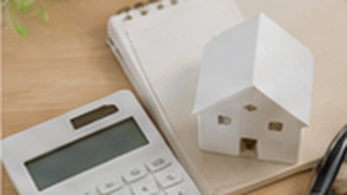 Calculator and house model used to plan initial apartment rental costs in Japan
