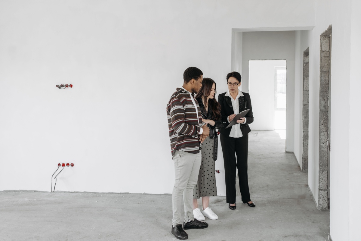 Prospective renters discussing an apartment with a real estate agent