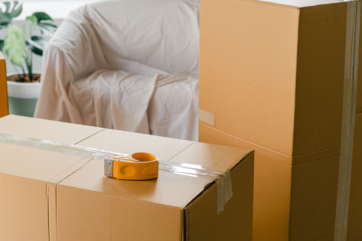 Packed moving boxes inside a bright apartment before moving out