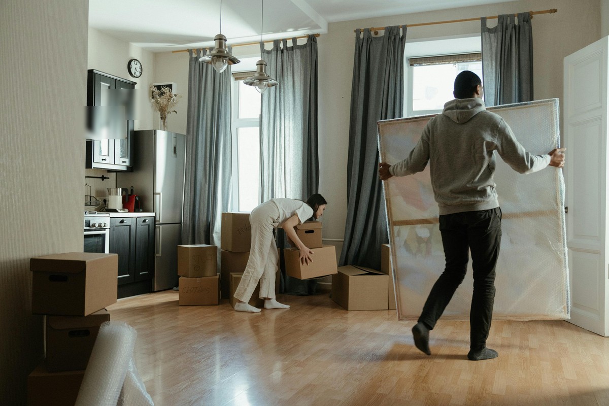 Residents packing a bright apartment when preparing to move