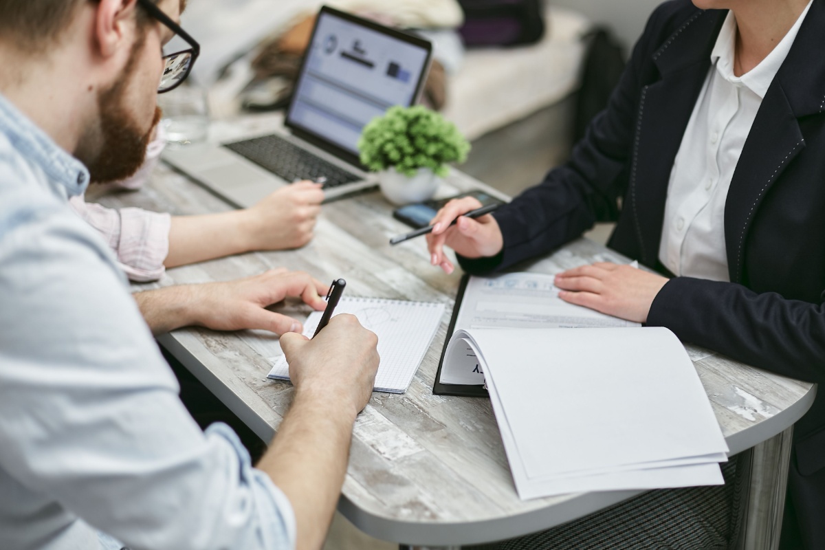 Resident discussing address documents with an office professional