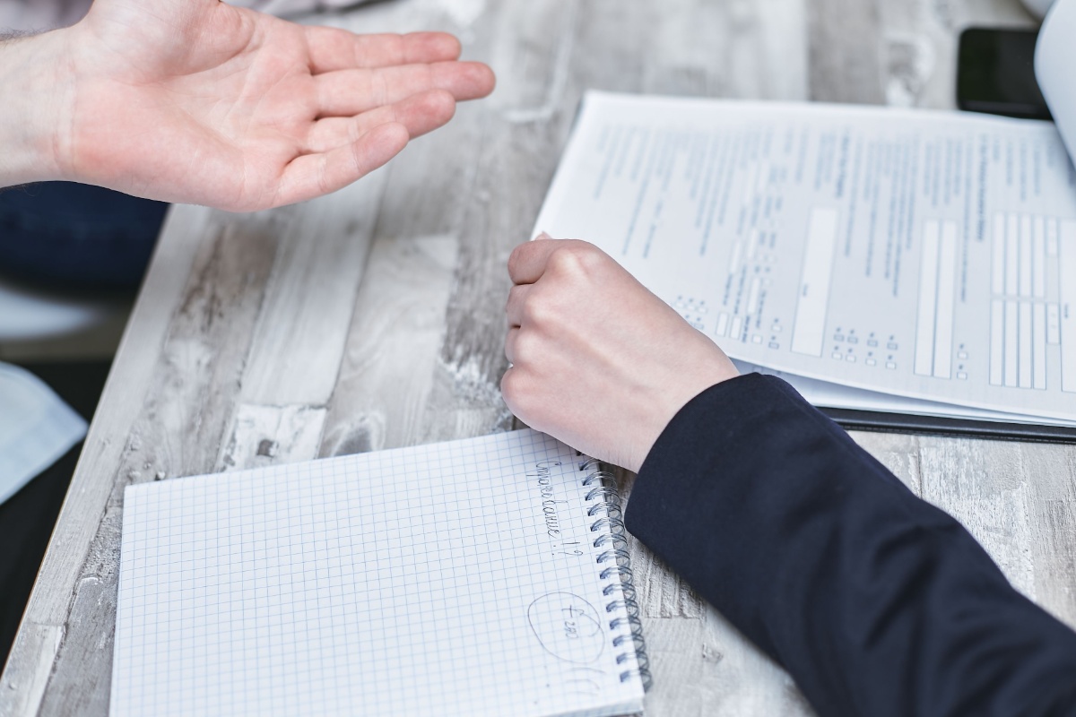 Applicant discussing My Number Card paperwork at an office counter